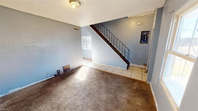 carpeted empty room with a wealth of natural light