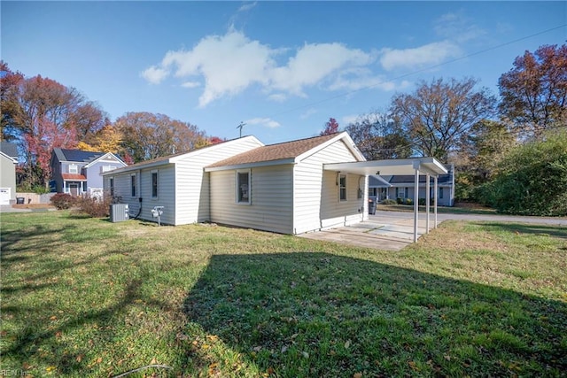 rear view of house featuring central AC, a yard, and a patio