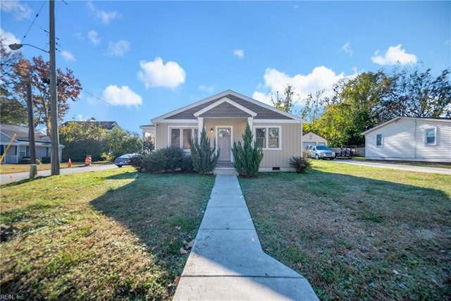 bungalow-style home with a front lawn