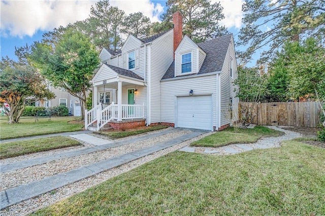 new england style home featuring a porch, a front yard, and a garage