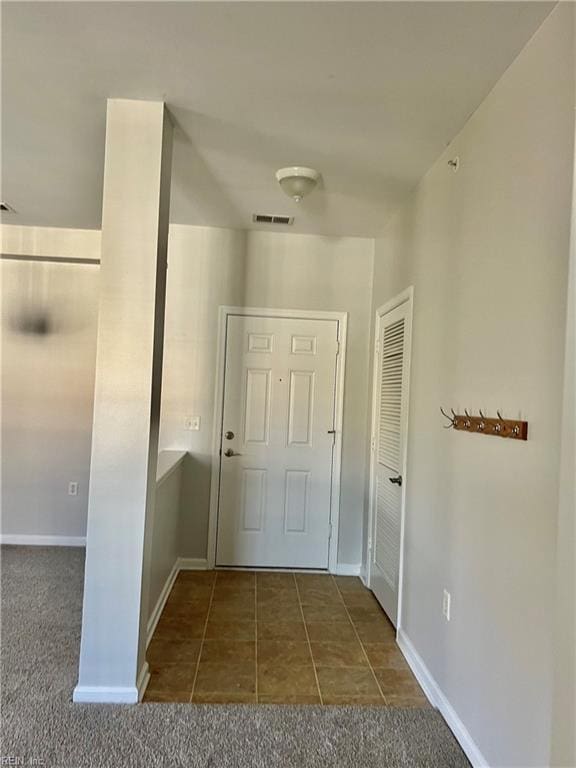 doorway featuring dark colored carpet