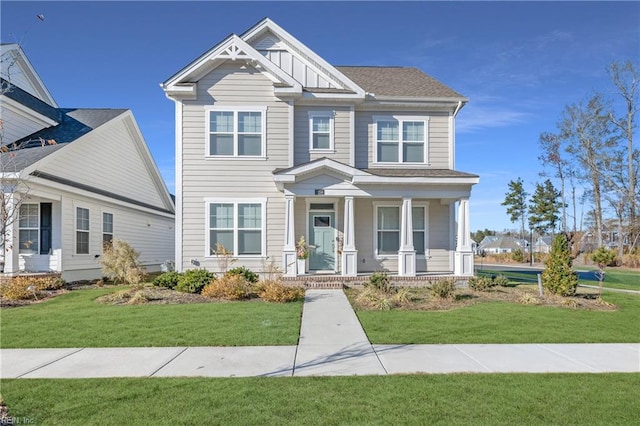 craftsman-style home featuring covered porch and a front yard