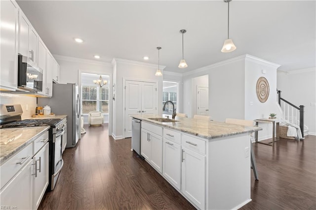 kitchen with stainless steel appliances, sink, a center island with sink, white cabinets, and dark hardwood / wood-style floors