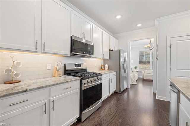 kitchen featuring light stone countertops, white cabinetry, dark wood-type flooring, and stainless steel appliances