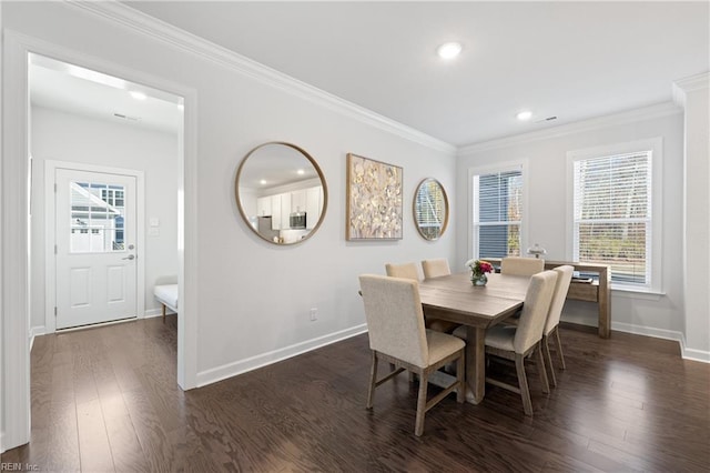 dining area with crown molding and dark hardwood / wood-style flooring