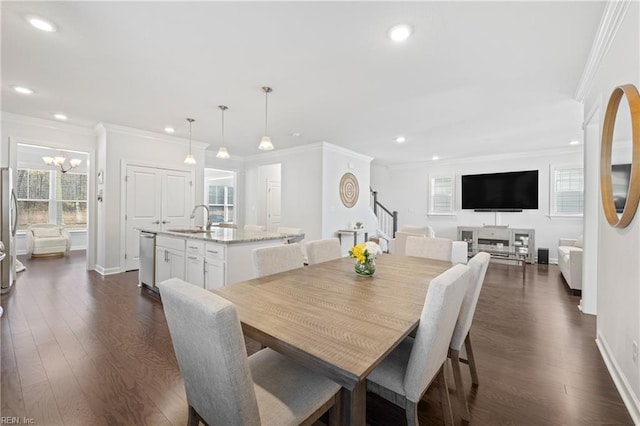 dining space featuring dark hardwood / wood-style floors, a healthy amount of sunlight, crown molding, and sink