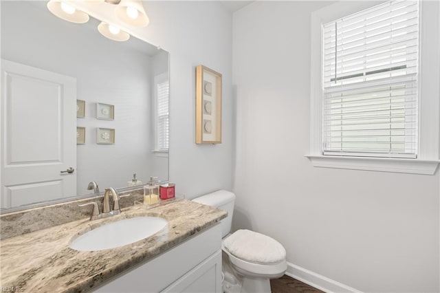 bathroom featuring vanity and toilet