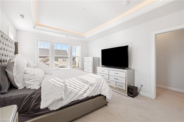 carpeted bedroom featuring a tray ceiling