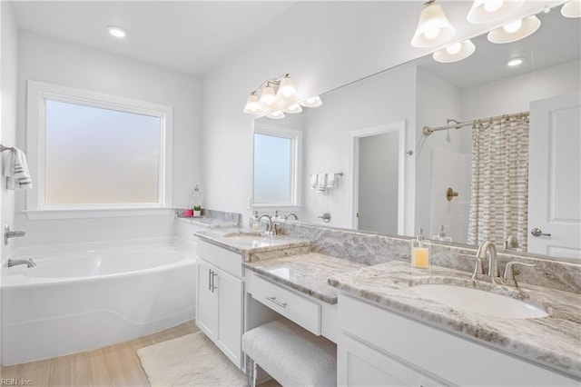 bathroom with vanity and independent shower and bath