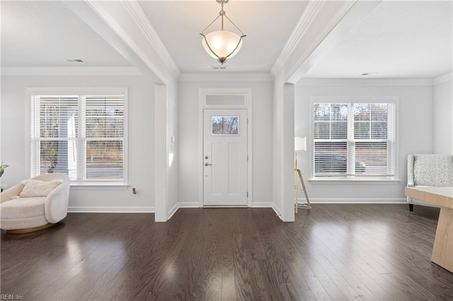 entryway with a healthy amount of sunlight, dark hardwood / wood-style floors, and ornamental molding