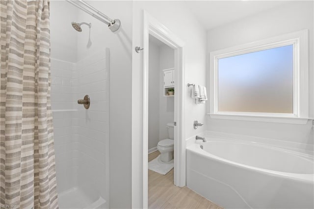 bathroom with hardwood / wood-style floors, independent shower and bath, and toilet