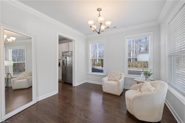 living area with dark hardwood / wood-style floors, crown molding, and an inviting chandelier