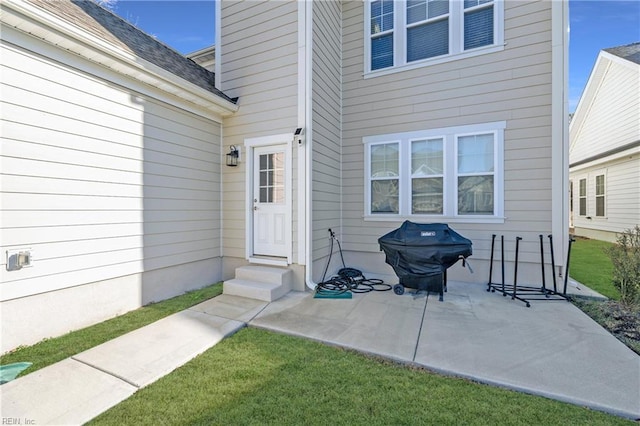 doorway to property featuring a yard and a patio