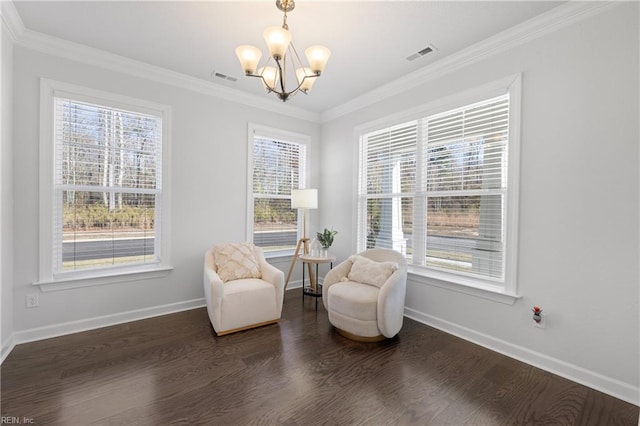 sitting room with dark hardwood / wood-style flooring, crown molding, and a notable chandelier