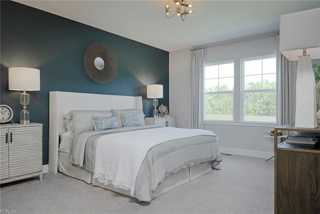 carpeted bedroom with an inviting chandelier