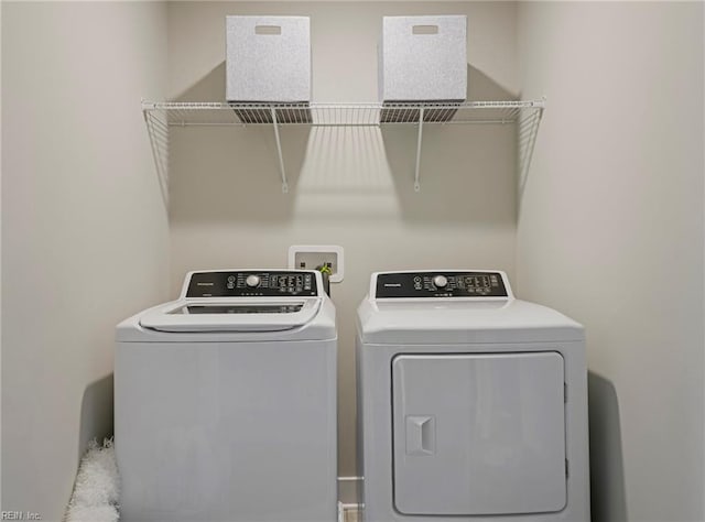 clothes washing area with washer and dryer