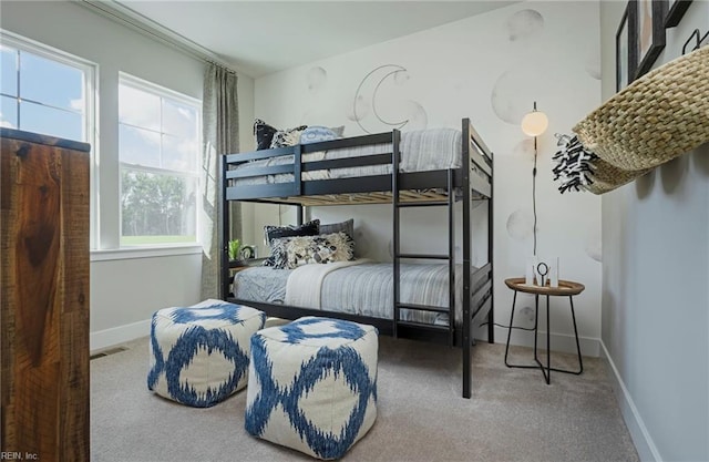 carpeted bedroom with multiple windows