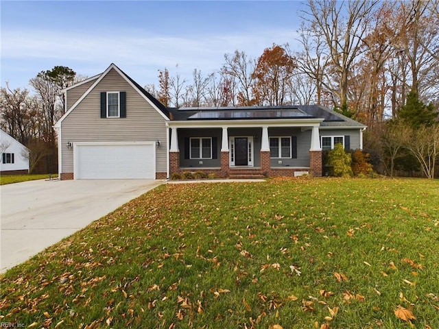 view of front facade with covered porch, a front yard, and a garage