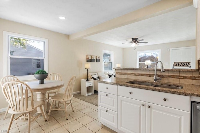 kitchen featuring white cabinets, sink, ceiling fan, decorative backsplash, and light tile patterned flooring