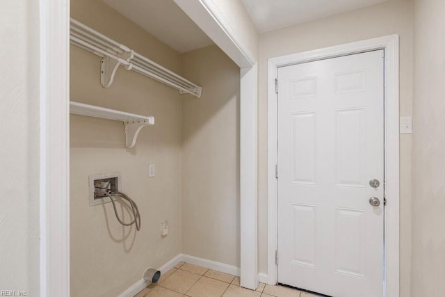 clothes washing area featuring washer hookup and light tile patterned flooring