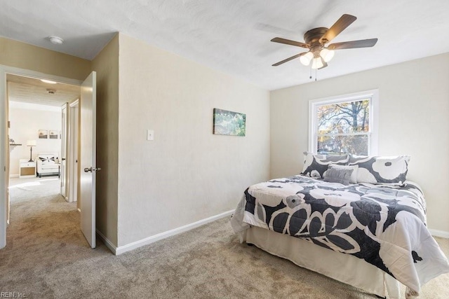 bedroom with ceiling fan and light carpet