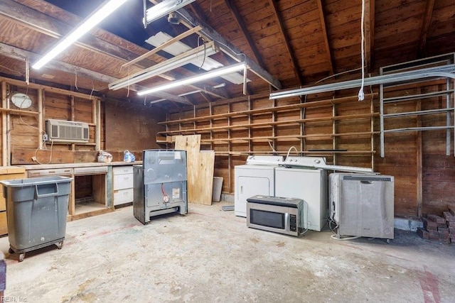 basement with a wall mounted air conditioner, fridge, and washer and clothes dryer