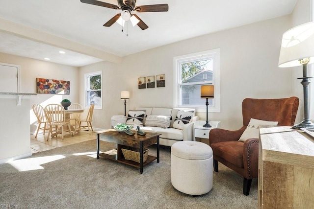 living room featuring ceiling fan and light colored carpet