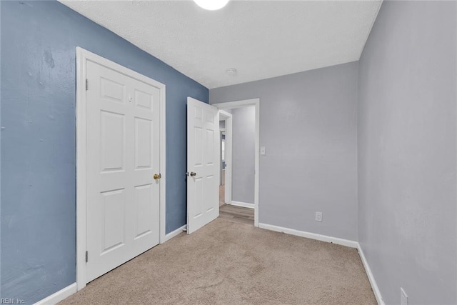 unfurnished bedroom with light colored carpet