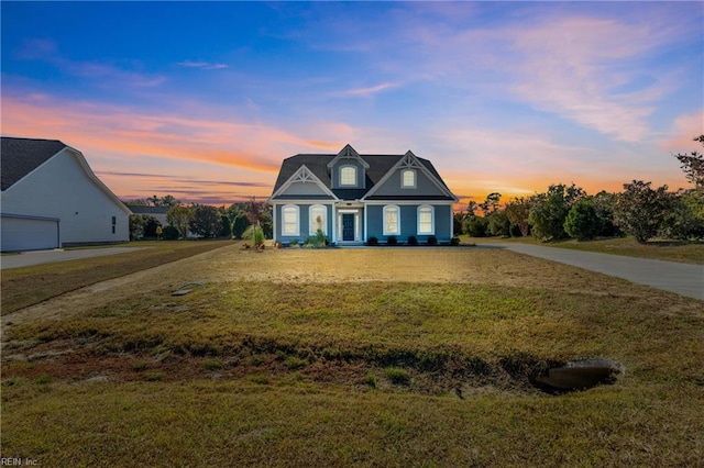 cape cod home with a yard