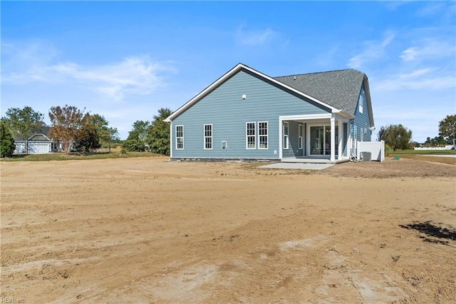 rear view of house with central AC