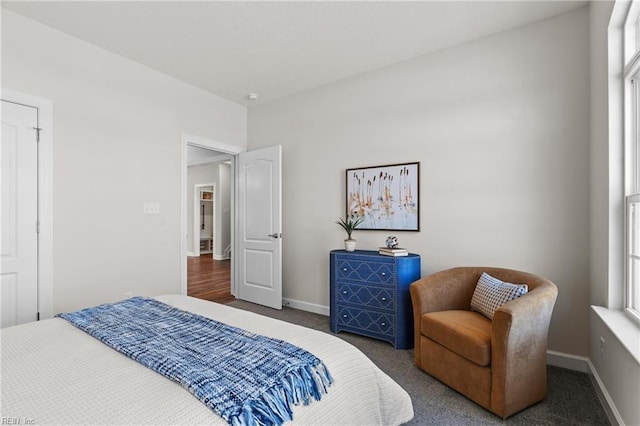 bedroom with dark colored carpet