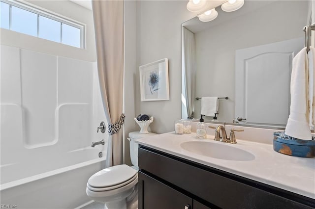 full bathroom with shower / bath combo, vanity, and toilet