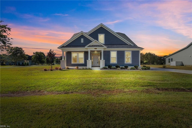 craftsman-style house with a yard