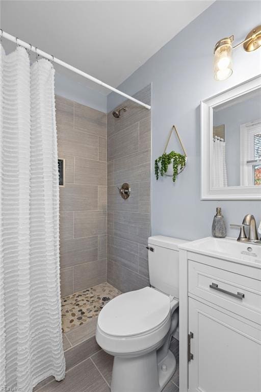 bathroom featuring tile patterned flooring, a shower with curtain, and vanity