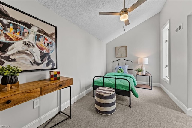 carpeted bedroom with a textured ceiling, ceiling fan, and lofted ceiling