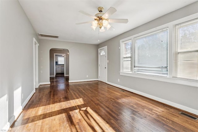 unfurnished room featuring dark hardwood / wood-style floors and ceiling fan