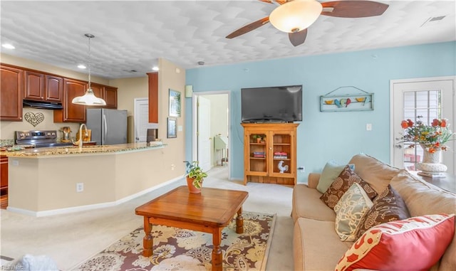 carpeted living room featuring sink