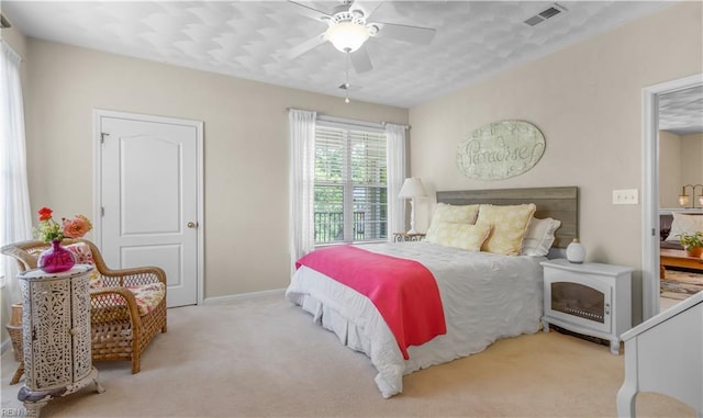 bedroom featuring ceiling fan and light carpet