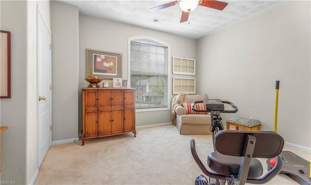 interior space featuring ceiling fan and light colored carpet