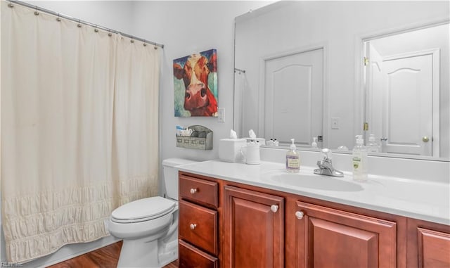 bathroom featuring hardwood / wood-style flooring, vanity, and toilet