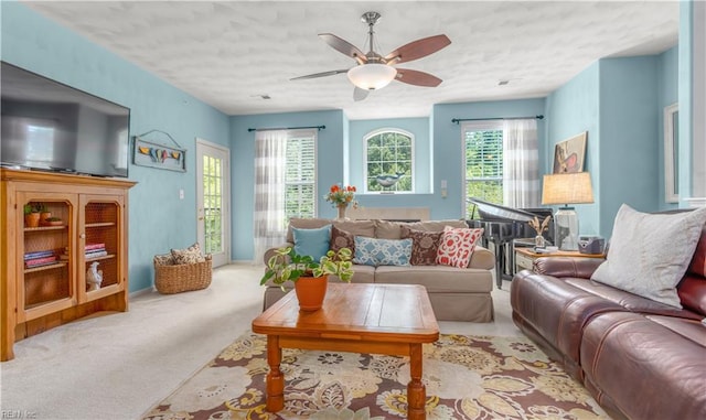 carpeted living room featuring ceiling fan