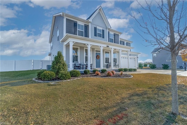 view of front of property with central air condition unit, covered porch, a front yard, and a garage