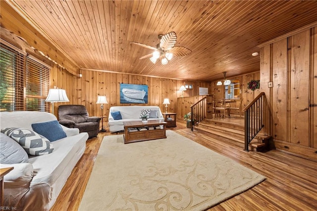 living room featuring wood ceiling, light hardwood / wood-style flooring, ceiling fan, and wood walls