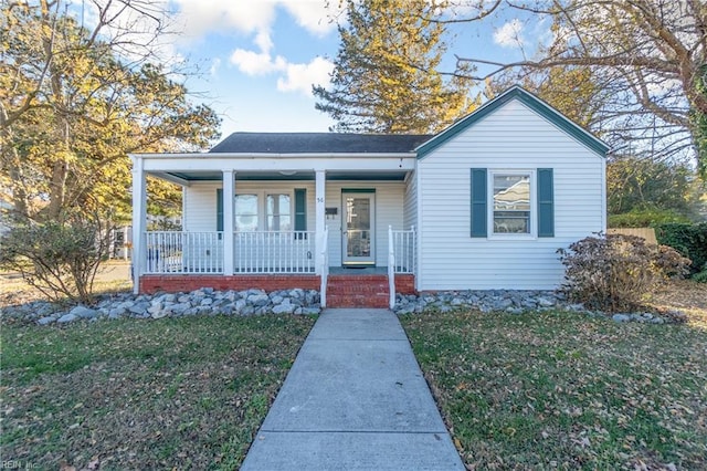 bungalow with a porch and a front yard