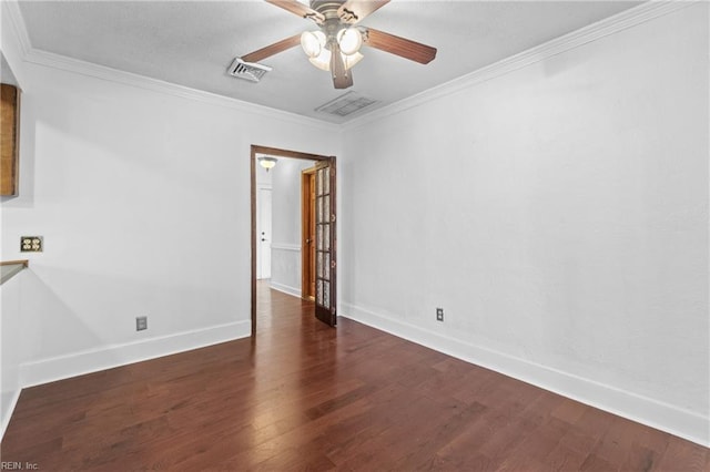 spare room featuring dark hardwood / wood-style flooring, ceiling fan, and crown molding