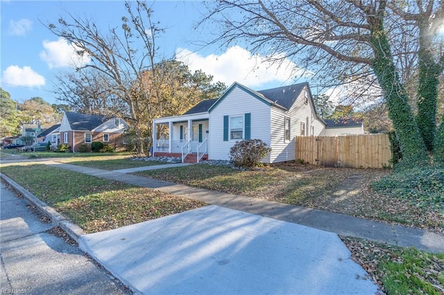 bungalow-style home featuring a porch and a front yard