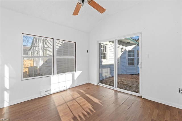 unfurnished room with hardwood / wood-style flooring, vaulted ceiling, and ceiling fan