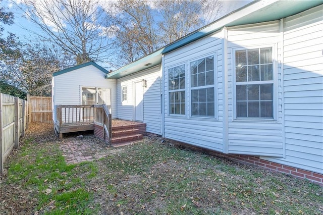 rear view of property featuring a deck