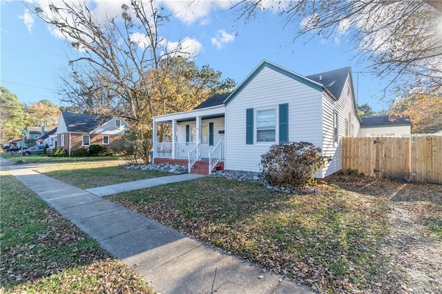 bungalow-style house with covered porch and a front yard