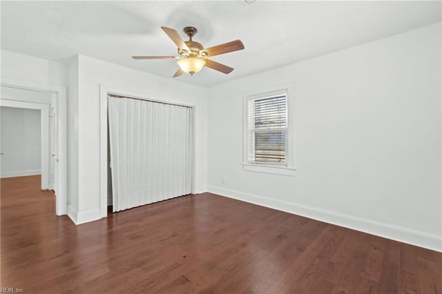 unfurnished bedroom featuring a closet, ceiling fan, and dark hardwood / wood-style flooring